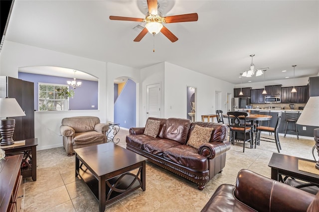12244 Fairlawn Dr, Riverview, FL 33579 - living area featuring a chandelier, arched walkways, light tile patterned floors, and a ceiling fan