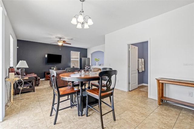 12244 Fairlawn Dr, Riverview, FL 33579 - dining room with ceiling fan, a chandelier, light tile patterned floors, and arched walkways