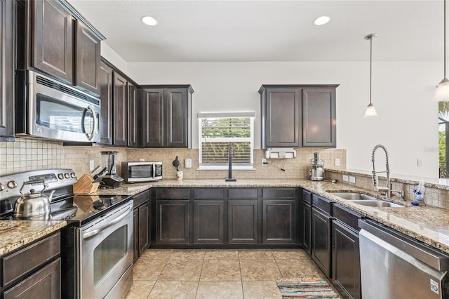 12244 Fairlawn Dr, Riverview, FL 33579 - kitchen with stainless steel appliances, light stone countertops, tasteful backsplash, dark brown cabinets, and recessed lighting