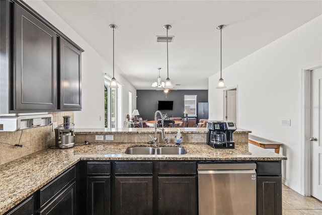 12244 Fairlawn Dr, Riverview, FL 33579 - kitchen featuring stainless steel dishwasher, backsplash, a peninsula, light stone countertops, and open floor plan