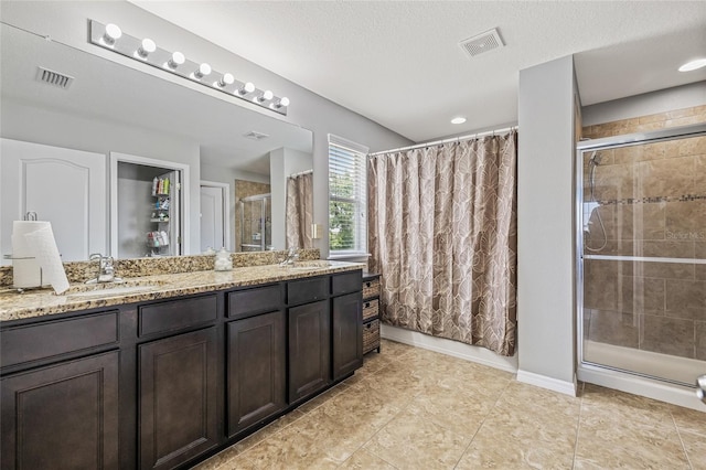 12244 Fairlawn Dr, Riverview, FL 33579 - full bath with a tile shower, double vanity, and a textured ceiling