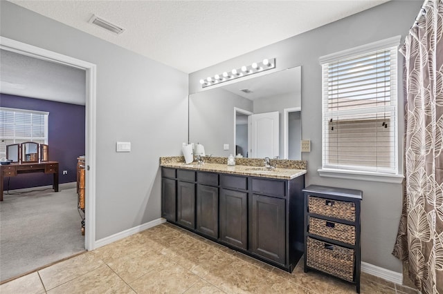 12244 Fairlawn Dr, Riverview, FL 33579 - bathroom featuring double vanity, plenty of natural light, and tile patterned flooring