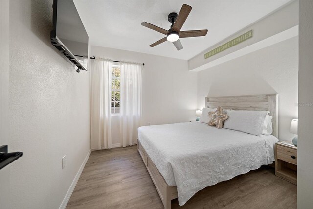 608 Bay Esplanade, Clearwater Beach, FL 33767 - bedroom with light wood-style flooring and a ceiling fan