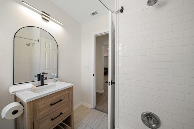 608 Bay Esplanade, Clearwater Beach, FL 33767 - bathroom with vanity and a tile shower
