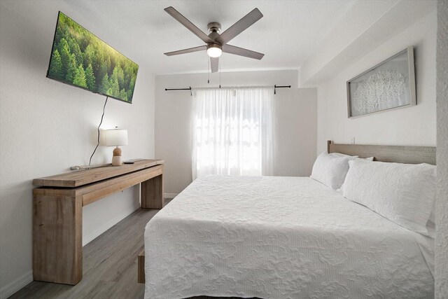608 Bay Esplanade, Clearwater Beach, FL 33767 - bedroom with wood finished floors and a ceiling fan