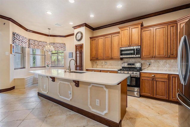 4400 English Turn Way, Wesley Chapel, FL 33543 - kitchen featuring appliances with stainless steel finishes, a sink, brown cabinetry, a center island with sink, and crown molding