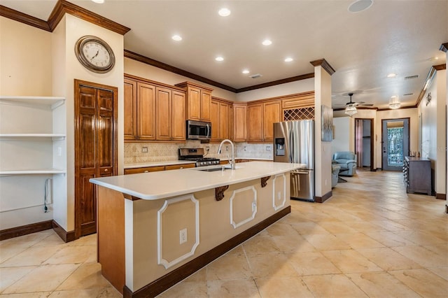 4400 English Turn Way, Wesley Chapel, FL 33543 - kitchen featuring appliances with stainless steel finishes, ornamental molding, light countertops, tasteful backsplash, and an island with sink