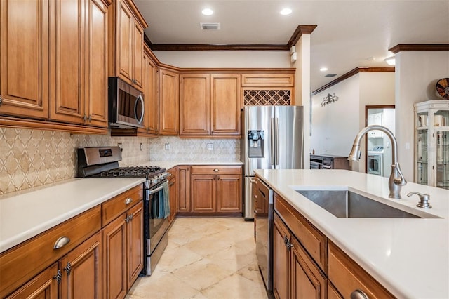 4400 English Turn Way, Wesley Chapel, FL 33543 - kitchen featuring stainless steel appliances, a sink, ornamental molding, brown cabinetry, and light countertops