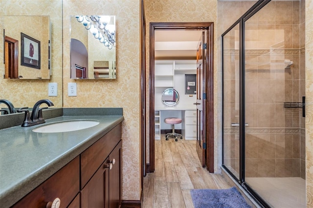 4400 English Turn Way, Wesley Chapel, FL 33543 - bathroom with wood finished floors, a stall shower, vanity, and wallpapered walls