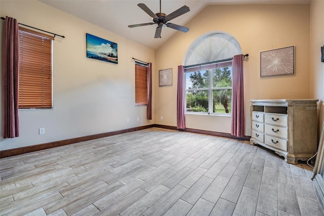 4400 English Turn Way, Wesley Chapel, FL 33543 - spare room with a ceiling fan, wood finished floors, baseboards, and high vaulted ceiling
