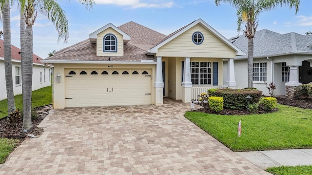 4400 English Turn Way, Wesley Chapel, FL 33543 - view of front of property featuring decorative driveway, stucco siding, a front lawn, and a shingled roof