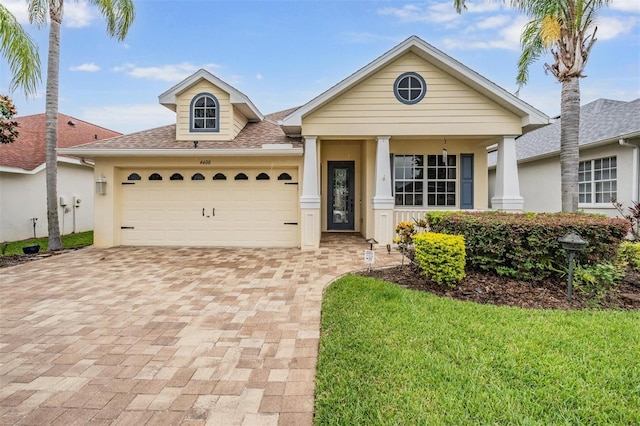 4400 English Turn Way, Wesley Chapel, FL 33543 - view of front of property featuring decorative driveway, a garage, stucco siding, and roof with shingles