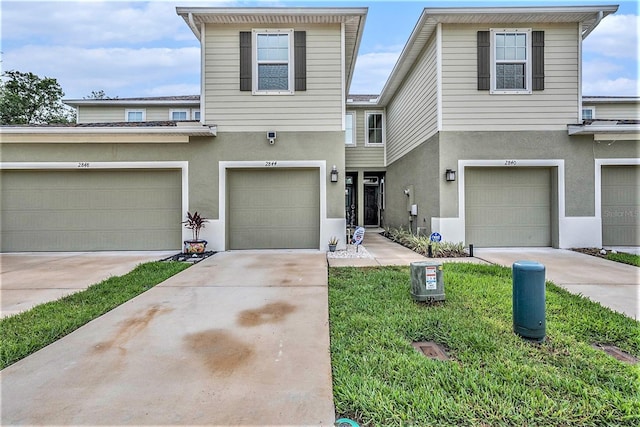 2844 Jacob Crossing Ln, Holiday, FL 34691 - view of front facade featuring stucco siding, driveway, and an attached garage