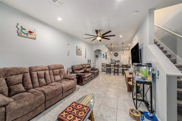 2844 Jacob Crossing Ln, Holiday, FL 34691 - living room featuring arched walkways, ceiling fan, stairway, recessed lighting, and light tile patterned floors
