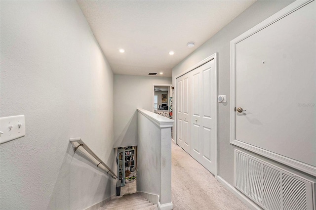 2844 Jacob Crossing Ln, Holiday, FL 34691 - hallway with an upstairs landing, baseboards, recessed lighting, and light colored carpet