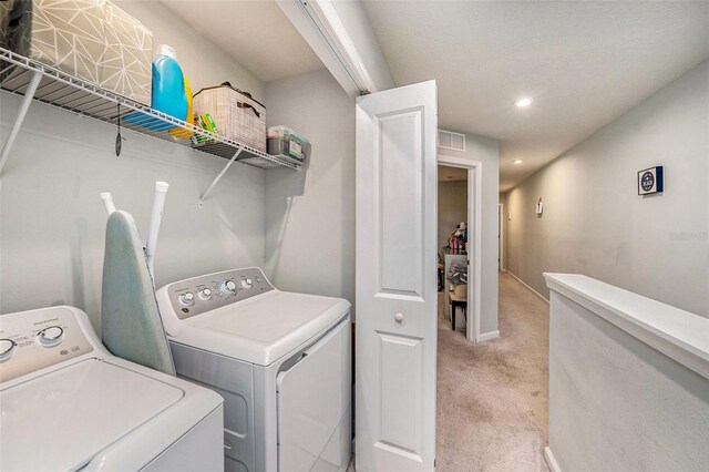 2844 Jacob Crossing Ln, Holiday, FL 34691 - laundry room with independent washer and dryer, light colored carpet, recessed lighting, and baseboards