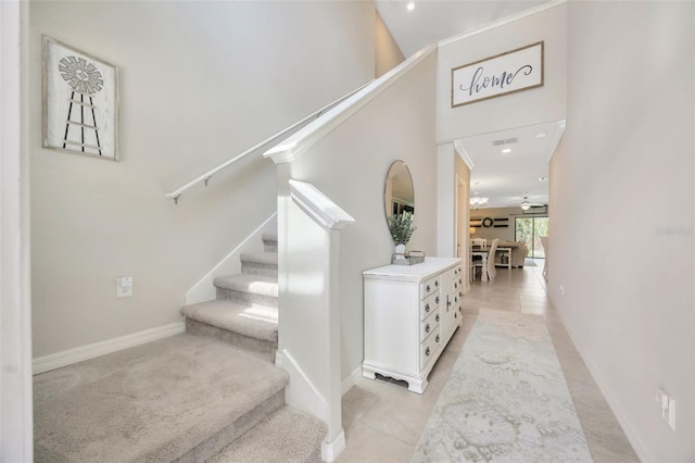 14716 Crescent Rock Dr, Wimauma, FL 33598 - staircase featuring baseboards, tile patterned floors, recessed lighting, and a high ceiling