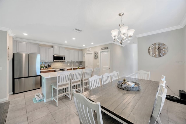 14716 Crescent Rock Dr, Wimauma, FL 33598 - dining room with light tile patterned floors, ornamental molding, a chandelier, recessed lighting, and baseboards