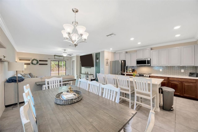 14716 Crescent Rock Dr, Wimauma, FL 33598 - dining room featuring ceiling fan, crown molding, a chandelier, light tile patterned floors, and recessed lighting