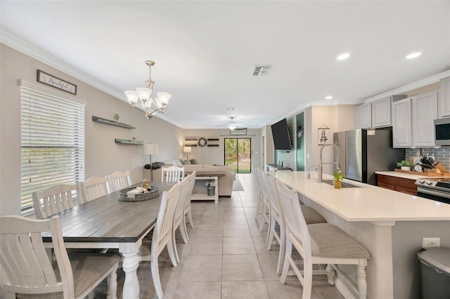 14716 Crescent Rock Dr, Wimauma, FL 33598 - dining area featuring ornamental molding, ceiling fan, light tile patterned flooring, a chandelier, and recessed lighting