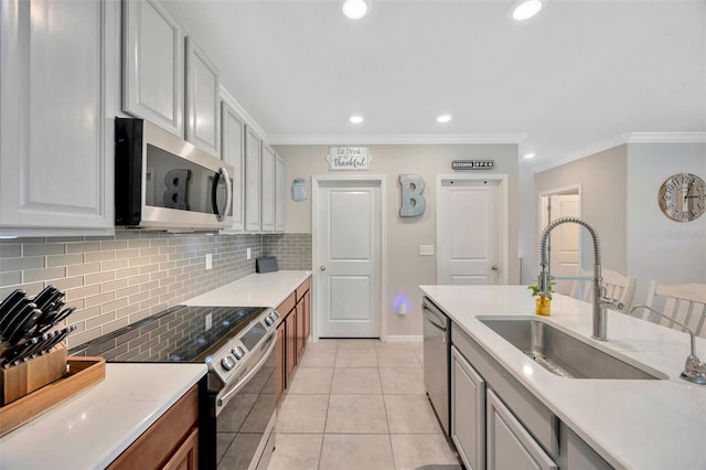 14716 Crescent Rock Dr, Wimauma, FL 33598 - kitchen featuring appliances with stainless steel finishes, a sink, backsplash, ornamental molding, and light countertops