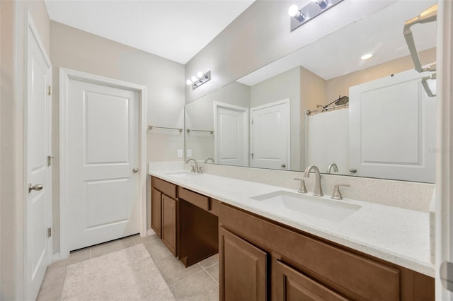 14716 Crescent Rock Dr, Wimauma, FL 33598 - bathroom with double vanity, tile patterned floors, and baseboards