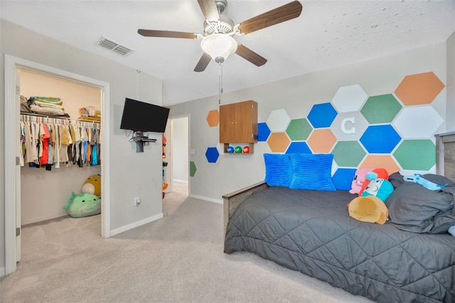 14716 Crescent Rock Dr, Wimauma, FL 33598 - bedroom featuring carpet floors, baseboards, ceiling fan, a walk in closet, and a closet
