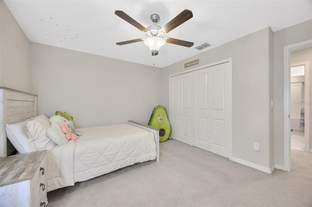 14716 Crescent Rock Dr, Wimauma, FL 33598 - bedroom featuring light colored carpet, a closet, baseboards, and ceiling fan