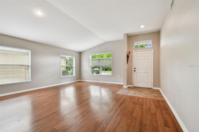 15709 Leatherleaf Ln, Land O Lakes, FL 34638 - entrance foyer featuring lofted ceiling, wood finished floors, baseboards, and recessed lighting