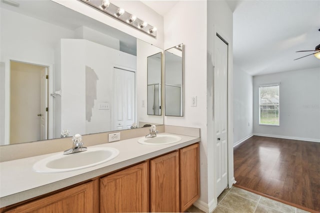 15709 Leatherleaf Ln, Land O Lakes, FL 34638 - bathroom with double vanity, ceiling fan, tile patterned flooring, and baseboards