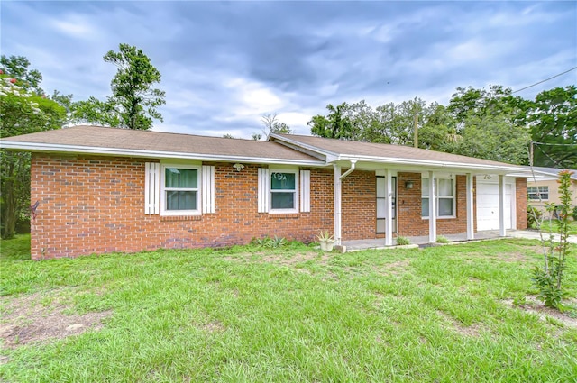 40019 Pretty Redbird Rd, Zephyrhills, FL 33540 - single story home featuring brick siding, a front yard, and a shingled roof