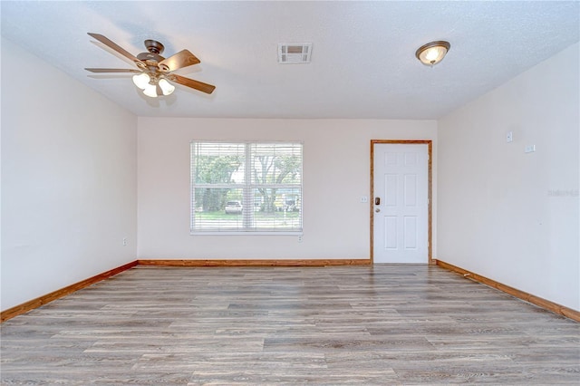 40019 Pretty Redbird Rd, Zephyrhills, FL 33540 - empty room featuring wood finished floors, baseboards, and ceiling fan