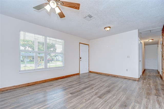 40019 Pretty Redbird Rd, Zephyrhills, FL 33540 - unfurnished room with light wood-style floors, baseboards, a textured ceiling, and a ceiling fan