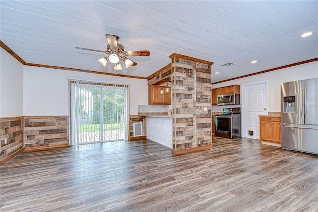 40019 Pretty Redbird Rd, Zephyrhills, FL 33540 - unfurnished living room with ornamental molding, a ceiling fan, wood finished floors, wainscoting, and recessed lighting