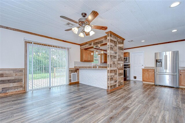 40019 Pretty Redbird Rd, Zephyrhills, FL 33540 - unfurnished living room featuring a ceiling fan, ornamental molding, wood finished floors, a sink, and recessed lighting