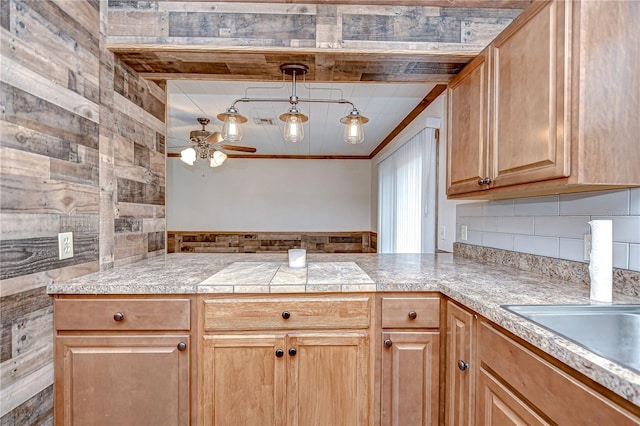 40019 Pretty Redbird Rd, Zephyrhills, FL 33540 - kitchen featuring a peninsula, ceiling fan, tile countertops, backsplash, and ornamental molding