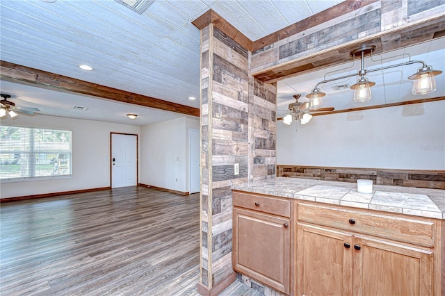 40019 Pretty Redbird Rd, Zephyrhills, FL 33540 - kitchen featuring a ceiling fan, beamed ceiling, wood finished floors, open floor plan, and light countertops