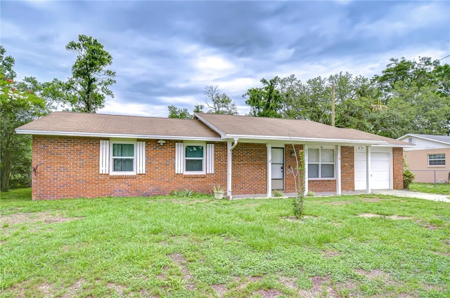 40019 Pretty Redbird Rd, Zephyrhills, FL 33540 - ranch-style home with brick siding, a front yard, a garage, and driveway
