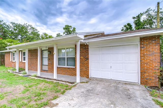 40019 Pretty Redbird Rd, Zephyrhills, FL 33540 - single story home with brick siding, an attached garage, and driveway