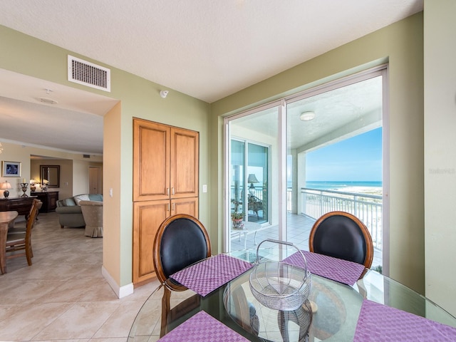 1170 Gulf Blvd Unit 1006, Clearwater Beach, FL 33767 - dining area featuring light tile patterned floors and a water view