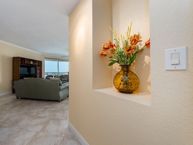 1170 Gulf Blvd Unit 1006, Clearwater Beach, FL 33767 - hall with crown molding, baseboards, tile patterned floors, and a textured wall