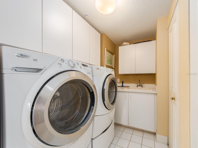 1170 Gulf Blvd Unit 1006, Clearwater Beach, FL 33767 - laundry area with washing machine and dryer, cabinet space, and light tile patterned flooring