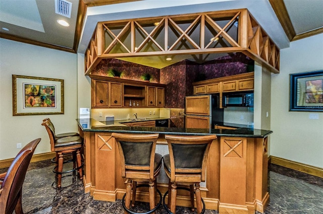 1170 Gulf Blvd Unit 1006, Clearwater Beach, FL 33767 - kitchen with refrigerator, black microwave, brown cabinets, dark countertops, and ornamental molding