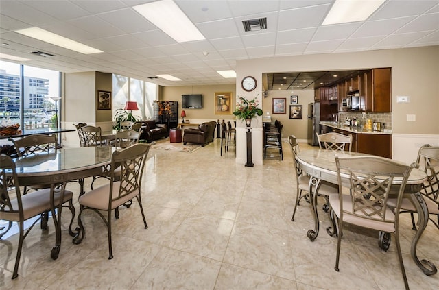 1621 Gulf Blvd Unit 407, Clearwater Beach, FL 33767 - dining space with a paneled ceiling, bar, and light tile patterned flooring