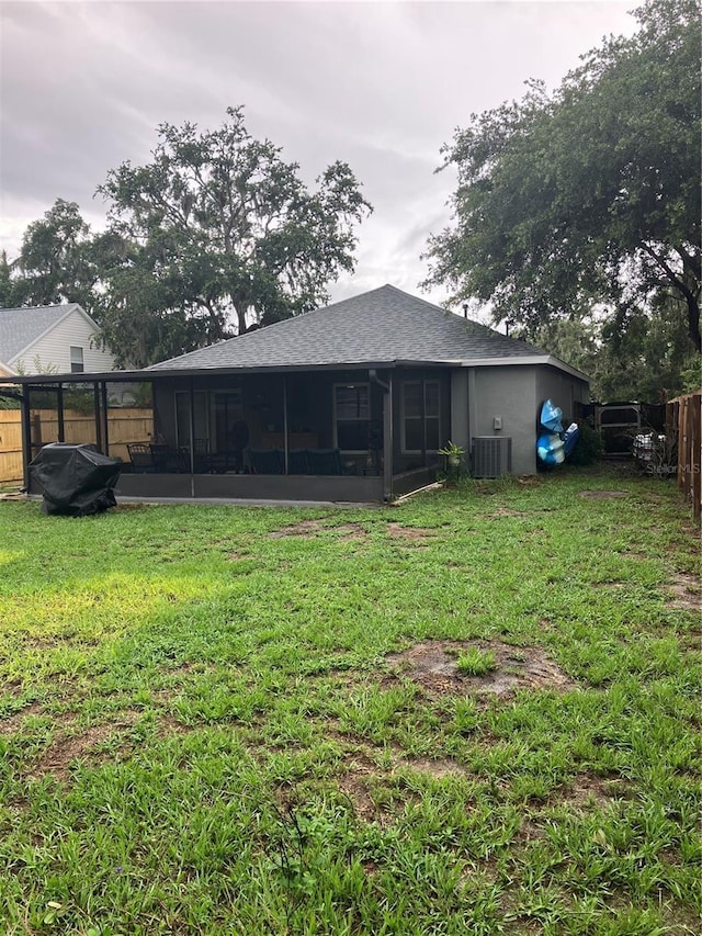 6905 Summer Harbor Ln, Riverview, FL 33578 - back of property featuring a sunroom, central air condition unit, and roof with shingles
