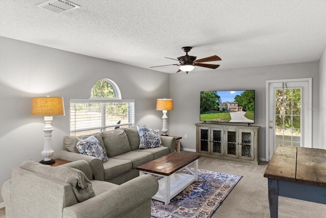 2541 W Castle Rd, Citrus Springs, FL 34434 - living area with ceiling fan, carpet, plenty of natural light, a textured ceiling, and baseboards