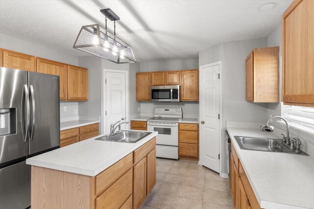 2541 W Castle Rd, Citrus Springs, FL 34434 - kitchen with stainless steel appliances, a sink, light countertops, a textured ceiling, and a kitchen island with sink
