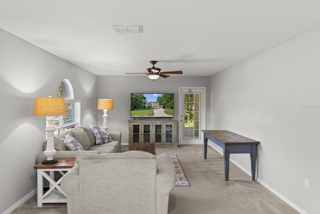2541 W Castle Rd, Citrus Springs, FL 34434 - living room with carpet, a ceiling fan, baseboards, and a textured ceiling
