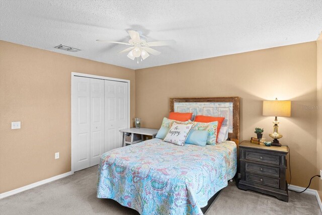 2541 W Castle Rd, Citrus Springs, FL 34434 - carpeted bedroom with baseboards, a closet, a ceiling fan, and a textured ceiling