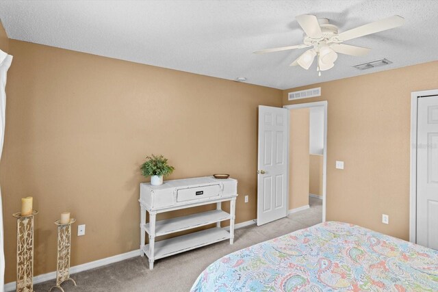 2541 W Castle Rd, Citrus Springs, FL 34434 - bedroom with carpet flooring, a ceiling fan, baseboards, and a textured ceiling